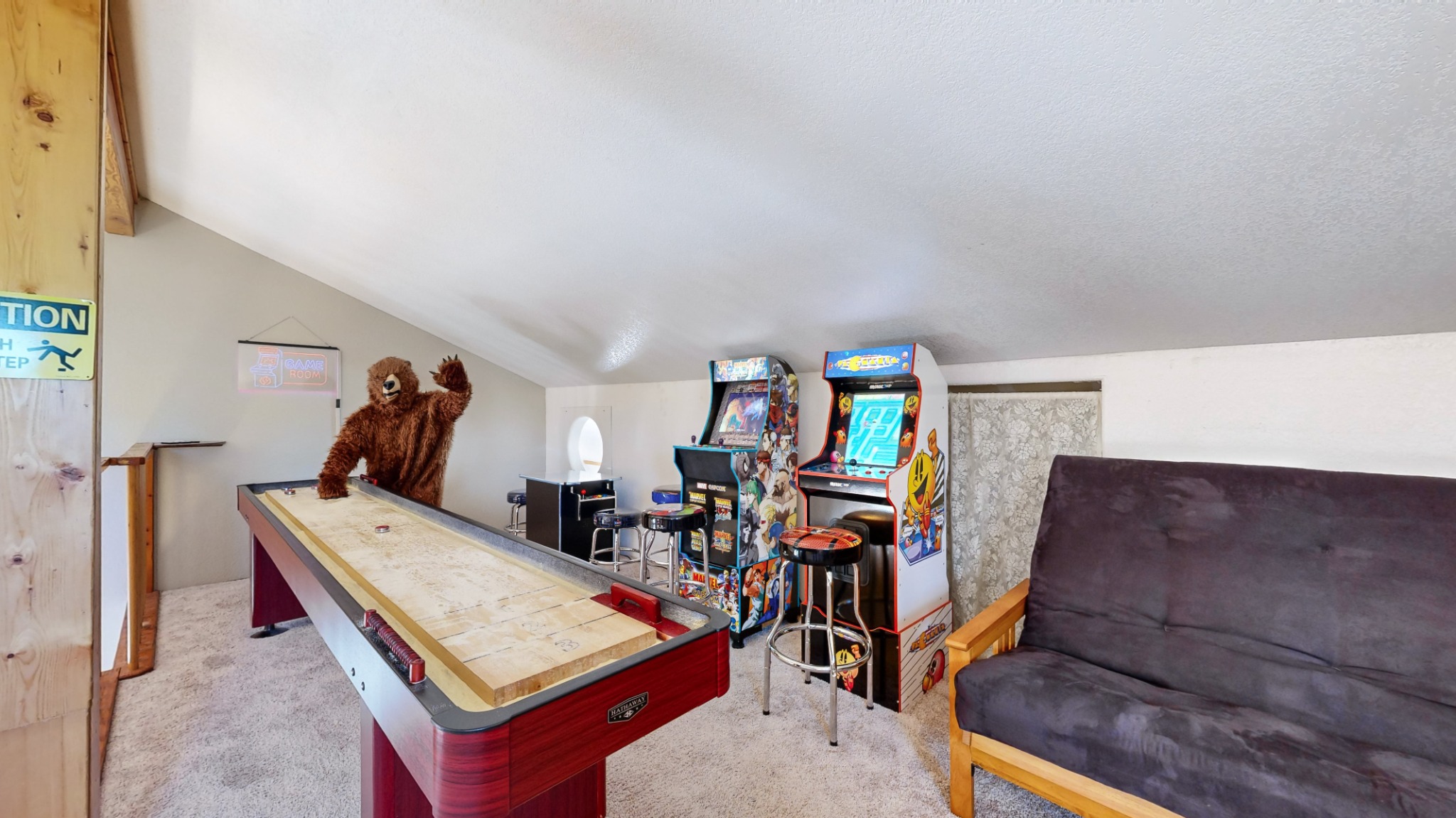Game loft with arcade machines and shuffleboard