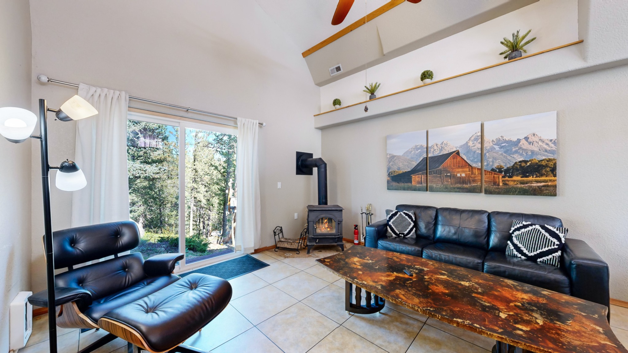 Living area with wood stove and mountain views