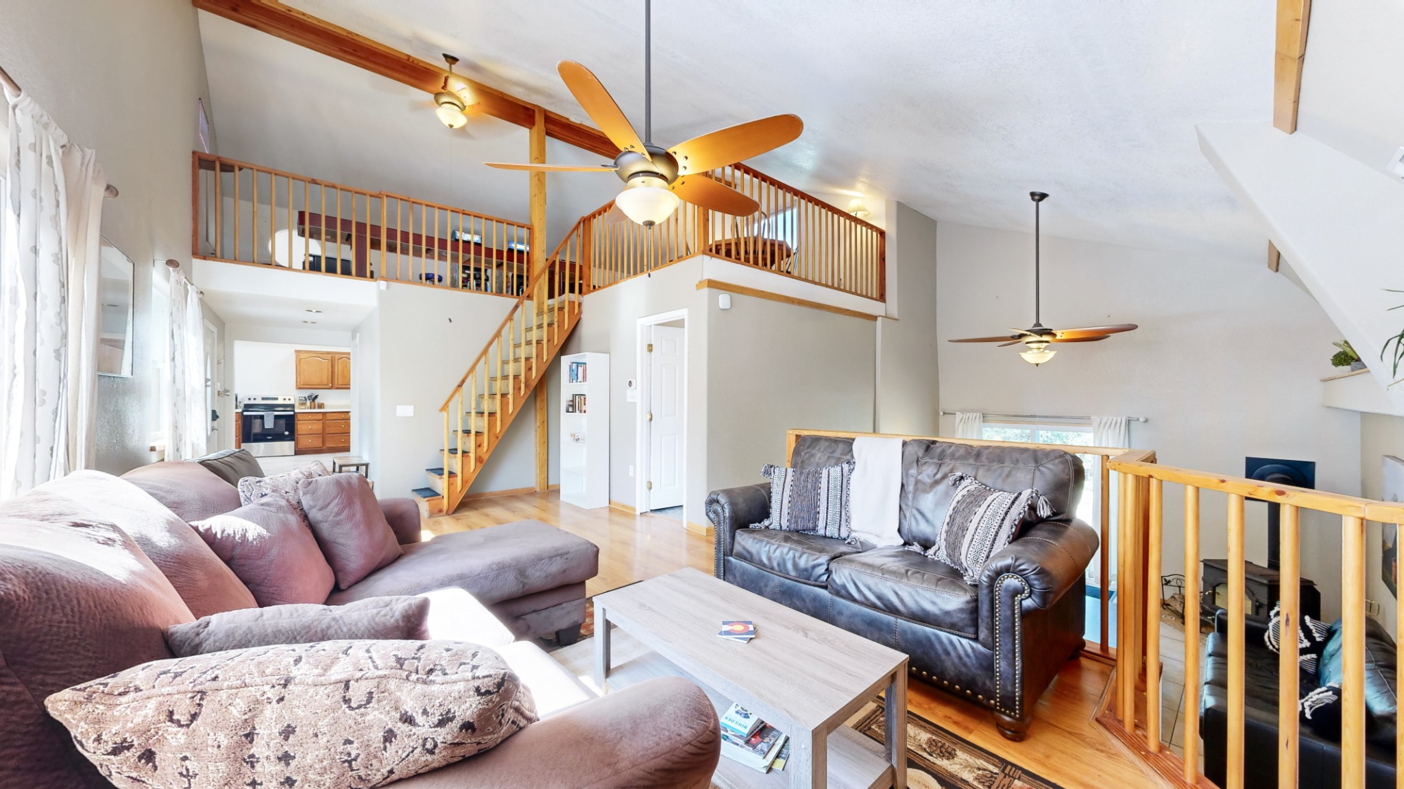 Open great room with vaulted ceilings and loft